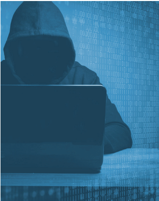 Hacker wearing a hoodie using a laptop