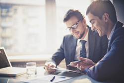 two businessmen discussing paperwork