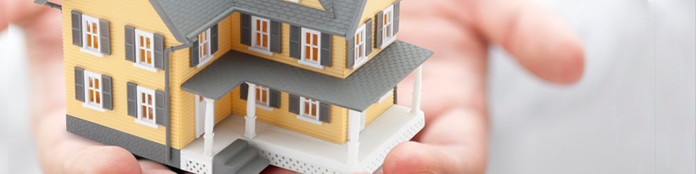 a model house being held in hands